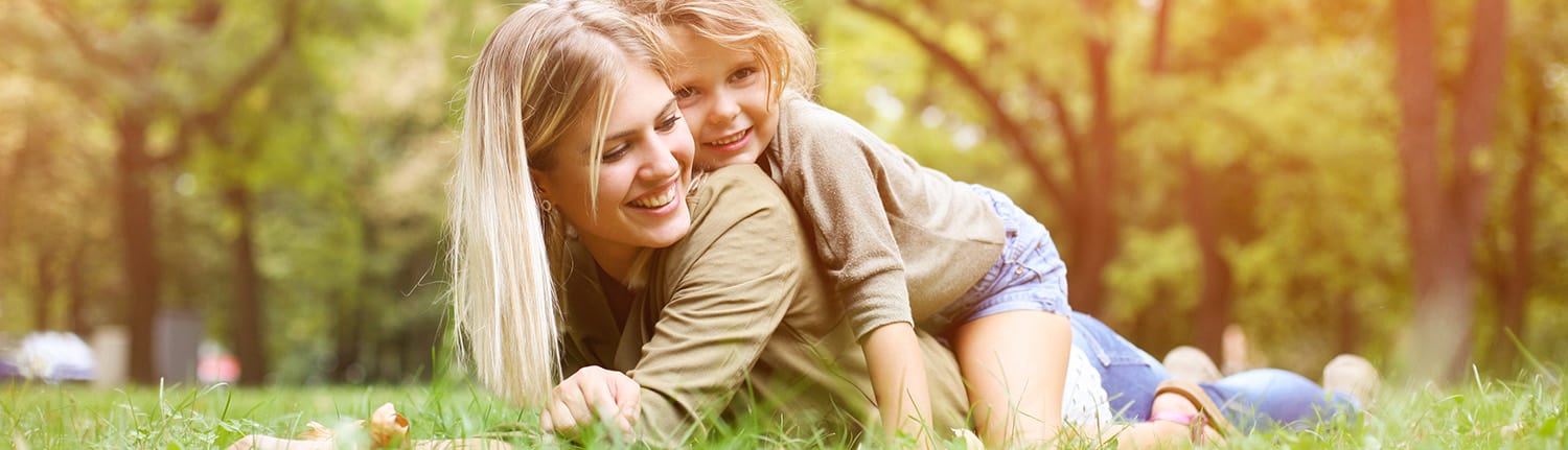 Little,Girl,Sitting,On,The,Mother,Back.,Cheerful,Mother,With